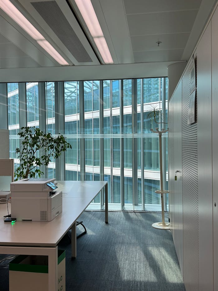 hero-img-02 Bright office space in Milano with tech setup, greenery, and architectural design.